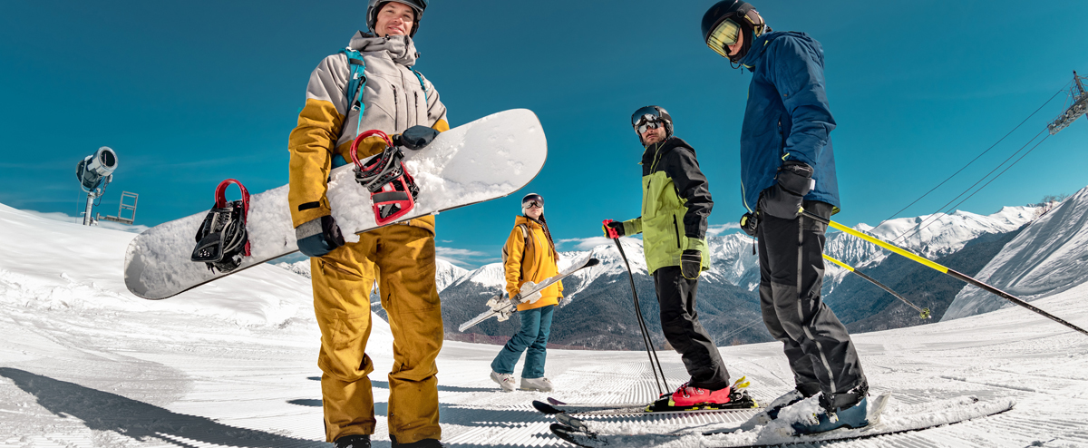 Small group of snowboarders and skiers on a mountain